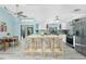 Open kitchen offers a large island with seating, stainless steel appliances, and backyard access at 4569 Kenvil Dr, North Port, FL 34288