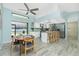 Kitchen with island, white cabinets, stainless steel appliances, and a view to the backyard at 4569 Kenvil Dr, North Port, FL 34288