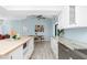 Open kitchen features a large island, white cabinets, stainless steel appliances and modern countertops at 4569 Kenvil Dr, North Port, FL 34288