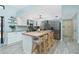 Bright kitchen features a large island with seating, stainless steel appliances, and light countertops at 4569 Kenvil Dr, North Port, FL 34288