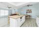 Bright open-concept living room and kitchen with modern appliances and island, with lots of natural light at 4569 Kenvil Dr, North Port, FL 34288