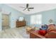 Comfortable living room with wood-look floors, ceiling fan, and a neutral color scheme at 4569 Kenvil Dr, North Port, FL 34288