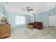 Open living room features vaulted ceilings, ceiling fan, and wood-look floors at 4569 Kenvil Dr, North Port, FL 34288