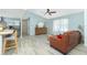 Inviting living room features wood-look flooring, vaulted ceiling, and a comfortable leather sofa at 4569 Kenvil Dr, North Port, FL 34288