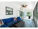 Screened-in porch featuring patio furniture, stylish ceiling fan, and a large sliding glass door at 4569 Kenvil Dr, North Port, FL 34288