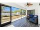 Screened porch with modern furniture and a view of the spacious, fenced backyard at 4569 Kenvil Dr, North Port, FL 34288