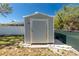 Backyard storage shed surrounded by green lawn, offering convenient space for tools and outdoor equipment at 4569 Kenvil Dr, North Port, FL 34288