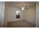 Comfortable carpeted bedroom with a ceiling fan and a window providing natural light at 4749 Oakley Rd, North Port, FL 34288