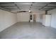 Spacious two-car garage with updated epoxy flooring, offering ample storage and workspace at 4749 Oakley Rd, North Port, FL 34288