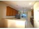 Well-lit kitchen boasts wooden cabinets, stainless steel appliances, and a cozy breakfast nook with a beautiful view at 4749 Oakley Rd, North Port, FL 34288