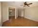 Spacious living room featuring hardwood floors and a ceiling fan with an open view to the dining room at 4749 Oakley Rd, North Port, FL 34288