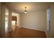 Bright living room with hardwood floors that opens to kitchen area at 4749 Oakley Rd, North Port, FL 34288