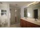 Main bathroom featuring a double vanity, walk-in shower, and tile flooring at 4749 Oakley Rd, North Port, FL 34288