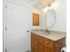 Cozy bathroom featuring a sink vanity, large mirror, and wood cabinets at 5611 Ganyard Ave, North Port, FL 34291