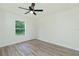 Bright bedroom featuring laminate flooring and a window overlooking a green outdoor space at 5611 Ganyard Ave, North Port, FL 34291
