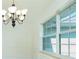 Dining area features wainscoting, tile floor, large window, and chandelier at 5611 Ganyard Ave, North Port, FL 34291