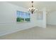 Bright dining area with tile flooring, wainscoting, and elegant lighting at 5611 Ganyard Ave, North Port, FL 34291
