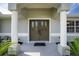 Elegant double front doors under a columned porch create a welcoming entrance at 5611 Ganyard Ave, North Port, FL 34291