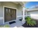 Elegant double front doors under a columned porch create a welcoming entrance at 5611 Ganyard Ave, North Port, FL 34291