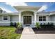 Inviting front entrance with double doors and decorative landscaping at 5611 Ganyard Ave, North Port, FL 34291