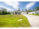 Charming single-story home with a well-manicured front lawn and a spacious driveway at 5611 Ganyard Ave, North Port, FL 34291