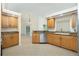 Bright kitchen with granite countertops, wood cabinets, stainless steel dishwasher, and tile flooring at 5611 Ganyard Ave, North Port, FL 34291