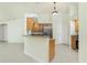 Bright kitchen with wood cabinets, granite countertops, stainless steel appliances, and tile flooring at 5611 Ganyard Ave, North Port, FL 34291