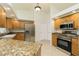 Kitchen showcasing granite countertops, wood cabinets, stainless steel appliances, and recessed lighting at 5611 Ganyard Ave, North Port, FL 34291