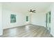 This living room features lots of windows, light walls and vinyl plank flooring at 5611 Ganyard Ave, North Port, FL 34291