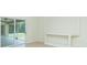 Living room showcasing a sliding glass door to a screened porch with custom built-in shelving at 5611 Ganyard Ave, North Port, FL 34291