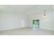 Bright living room with tile floors and sliding glass doors to the lanai at 5611 Ganyard Ave, North Port, FL 34291