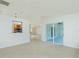 Spacious living room with tile flooring, leading to a screened-in porch and kitchen at 5611 Ganyard Ave, North Port, FL 34291