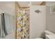 Full bathroom with shower/tub combo, tiled shower walls, and coastal decor at 6235 Bixel Ln, Englewood, FL 34224