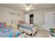 Inviting bedroom features two twin beds, a ceiling fan, and a closet at 6235 Bixel Ln, Englewood, FL 34224