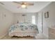 Bright bedroom featuring coastal decor, tile floors, a ceiling fan, and a view of the white dresser at 6235 Bixel Ln, Englewood, FL 34224