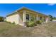 This property boasts a charming design, beautiful landscaping, and a well-manicured lawn at 6235 Bixel Ln, Englewood, FL 34224