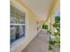 Inviting front porch with seating, decorative flamingo, and plant accents at 6235 Bixel Ln, Englewood, FL 34224