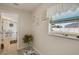 Hallway with plant stand, view of the dining area, and a window with outdoor view at 6235 Bixel Ln, Englewood, FL 34224