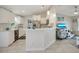 Bright eat-in kitchen features white cabinetry, stainless steel appliances, and pendant lighting at 6235 Bixel Ln, Englewood, FL 34224