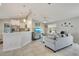 Open-concept living room with access to the kitchen and tile flooring at 6235 Bixel Ln, Englewood, FL 34224