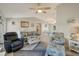 Open living room featuring a ceiling fan and coastal decor at 6235 Bixel Ln, Englewood, FL 34224