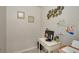 Small home office with white desk, artwork, computer, and a compact printer at 6235 Bixel Ln, Englewood, FL 34224