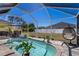 This screened-in pool area provides a cool escape, complete with an egg chair and an outdoor dining set at 6235 Bixel Ln, Englewood, FL 34224