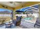 Screened patio area with a pool, outdoor seating, and landscaping at 6235 Bixel Ln, Englewood, FL 34224