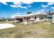 Home exterior with a hot tub and patio and lawn at 6272 Sooner St, North Port, FL 34287