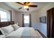 Bedroom featuring a ceiling fan, a mounted television, and natural light at 6272 Sooner St, North Port, FL 34287
