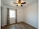 Cozy bedroom featuring a ceiling fan, window with curtains, and new flooring at 6272 Sooner St, North Port, FL 34287