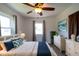 Comfortable bedroom with white walls, ceiling fan, bright natural light, and beach-themed decor at 6272 Sooner St, North Port, FL 34287