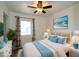 Bright bedroom with ceiling fan, a beach-themed painting and stylish furnishings at 6272 Sooner St, North Port, FL 34287