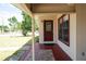 Inviting front porch with a decorative glass door and a view of the landscaped front yard at 6272 Sooner St, North Port, FL 34287